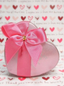 pink-ribbon-tied-over-pink-heart-shaped-tin-container