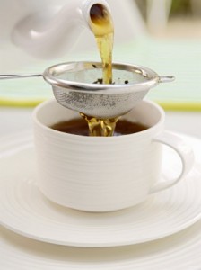 winfried-heinze-pouring-tea-through-a-tea-strainer
